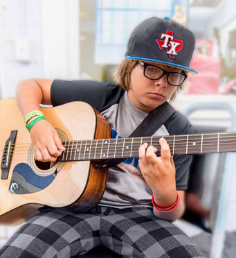 kid playing guitar