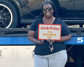 Donor holding JunkForJoy sign